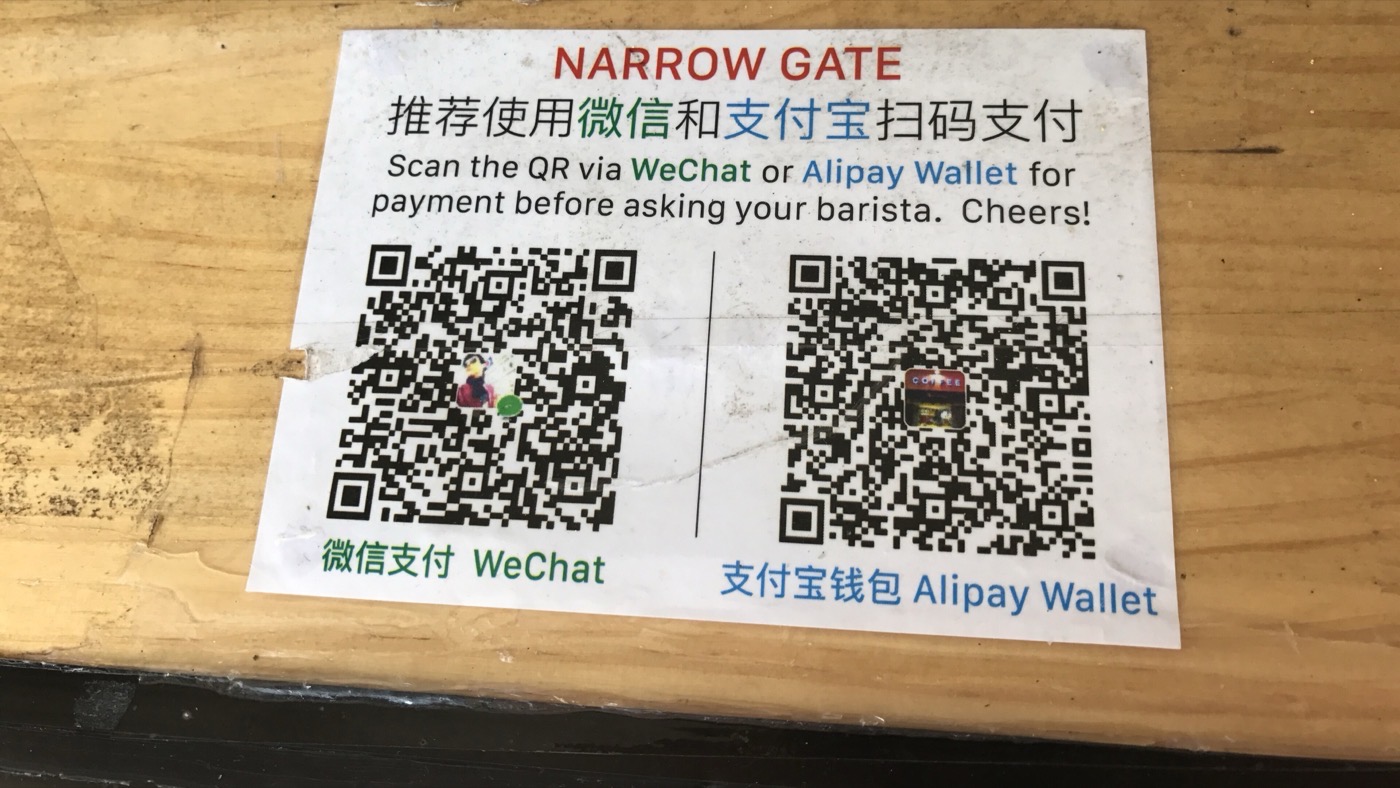 Payment QR codes taped to a counter at a shop in China